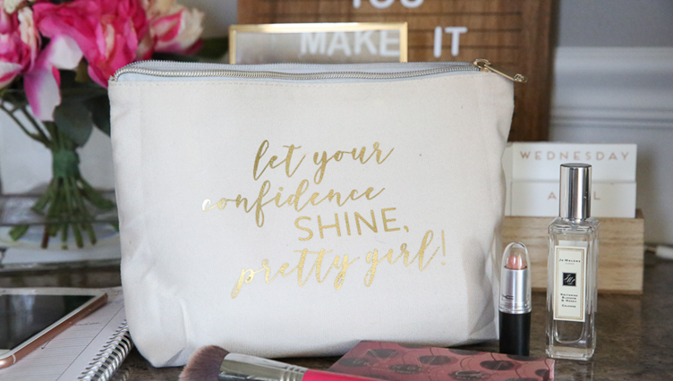 A white makeup bag that has the “Let your confidence shine, pretty girl!” logo for a Christmas gift